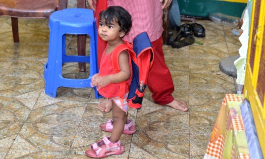 Ready for School, with her bag and her sister's shoes.