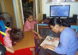 Barnani reading to Kalpana and Ganga from her frvorite story book.