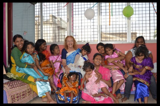 A picture of all the girls of Shishur Sevay and Dr. Harrison on her birthday