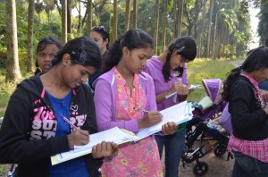 Girls taking notes at the botanical gardens.